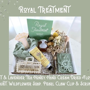 May include: A gift box labeled "Royal Treatment" containing a variety of self-care items. Includes a green box of tea, honey, hand cream, a dried flower bouquet, wildflower soap, a pearl claw clip, and a scrunchie. The box is presented on a light green background.
