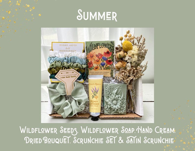 May include: A gift box with the word "Summer" at the top. The box contains a scrunchie set, a satin scrunchie, wildflower seeds, a dried bouquet, wildflower soap, and honey lavender hand cream. The text "To have and to hold your hair back" is visible.