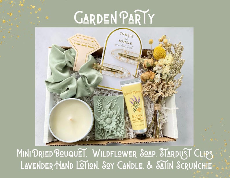 May include: A gift box labeled "Garden Party" containing a mini dried bouquet, wildflower soap, stardust clips, lavender hand lotion, a soy candle, and a satin scrunchie. The box includes a light green satin scrunchie and a bar of green soap with a floral design.