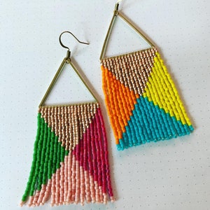 May include: Two pairs of colorful beaded earrings with gold triangle frames. The earrings are made of small beads in shades of pink, green, orange, yellow, and blue.