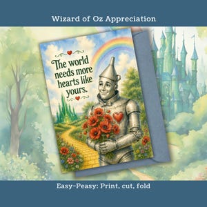 May include: Greeting card featuring the Tin Man from The Wizard of Oz, holding red poppies. The card has a rainbow, yellow brick road, and the text "The world needs more hearts like yours." A blue envelope is included.