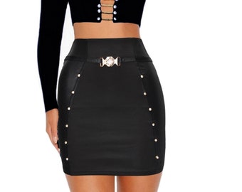 May include: A black off-the-shoulder crop top with a gold chain and pearl accents. The top is paired with a black mini skirt with a gold buckle and gold studs.