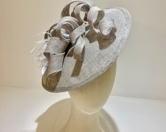 Silver grey fascinator (Valetta); swirls and feather detail. Available in other colours.