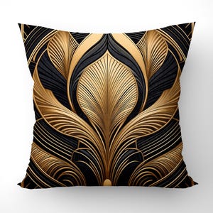 May include: A decorative throw pillow with a black and gold geometric pattern. The pattern features a stylized floral design with intricate lines and curves.