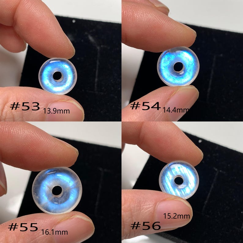 May include: Four iridescent moonstone beads with a hole in the centre. The beads are different sizes, ranging from 13.9 mm to 16.1 mm. Each bead is labelled with a number and its diameter in millimetres.
