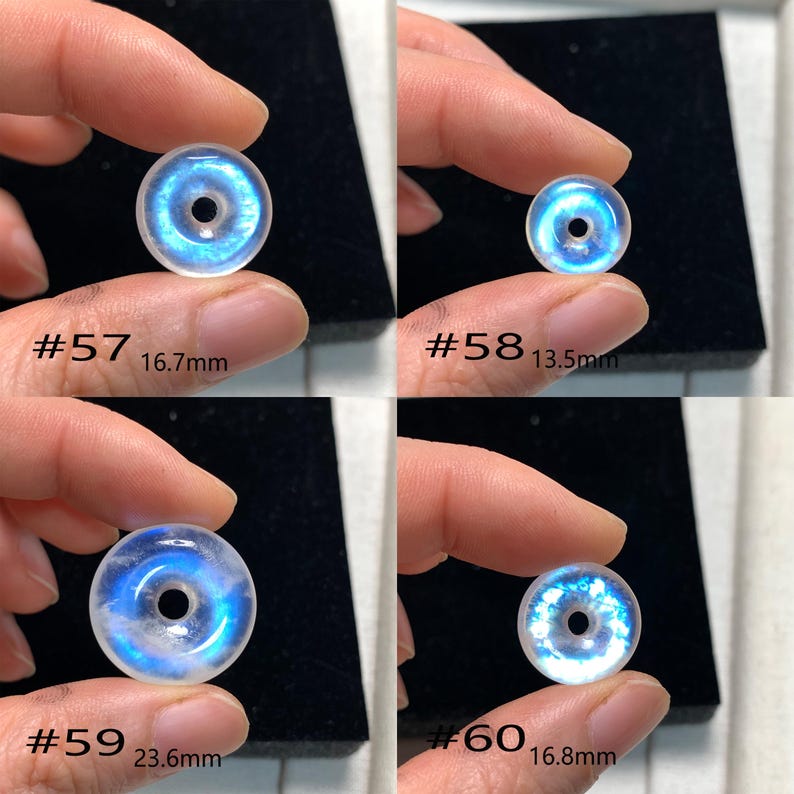 May include: Four iridescent white gemstone donut beads with a blue centre. The beads are labelled #57, #58, #59, and #60 with their respective diameters in millimetres.