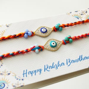 Lot de 2 rakhis mauvais œil | Raksha Bandhan pour frères et sœurs avec carte Premium