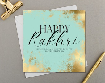 May include: A square greeting card with a mint green background and gold foil texture accents. The text reads HAPPY Rakhri, followed by SENDING LOVE AND BEST WISHES TO YOU ON THIS SPECIAL DAY. The card is placed on a white envelope.
