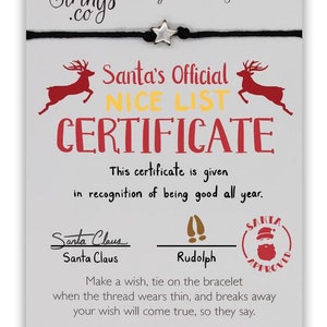 May include: A white card with red and yellow text that reads "Santa's Official Nice List Certificate". The card has a black string bracelet with a silver star charm. The text also reads "This certificate is given in recognition of being good all year." and is signed by "Santa Claus" and "Rudolph". The card also has a red stamp that reads "Santa Approved".