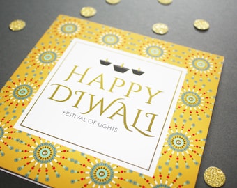 May include: A white card with a gold border and a yellow background with a repeating pattern of blue and red circles. The card says "Happy Diwali" in gold lettering and "Festival of Lights" in black lettering.