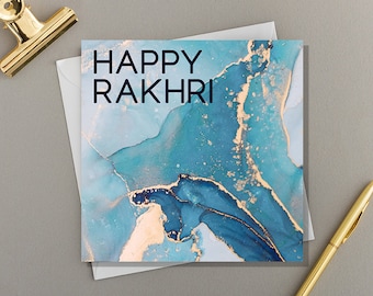 May include: A blue and gold card with the text "HAPPY RAKHRI" in black.