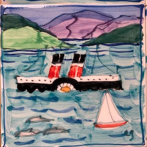 May include: A hand-painted ceramic tile depicting a black and white steamship with red smokestacks sailing on a blue sea with white waves.  There are three dolphins swimming in the water and a small red and white sailboat in the foreground.