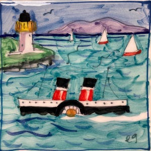 May include: A hand-painted ceramic tile depicting a seascape with a lighthouse, a paddle steamer, and sailboats. The tile has a blue background with green and white waves, a purple mountain in the distance, and a white lighthouse with a yellow top. The paddle steamer is black with red accents and a white deck. The sailboats are white with red accents. The tile is signed "eg" in the lower right corner.