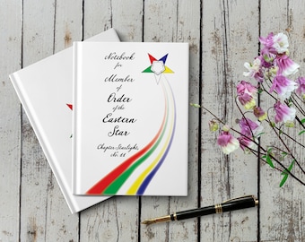 May include: White notebook with a rainbow design and the text "Notebook for Member of Order of the Eastern Star Chapter Starlight, No. 14".