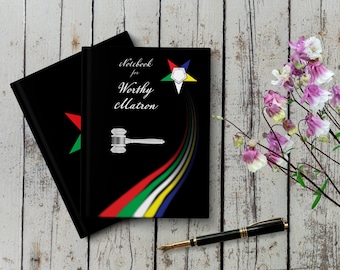 May include: Two black notebooks with a gavel and a five-pointed star with a white circle in the center. The text on the notebook reads "Notebook for Worthy Patron".