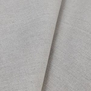 May include: Close-up of a light gray fabric with a woven texture. The fabric is folded in half, showing the smooth surface on one side and the textured surface on the other.