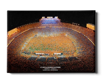 May include: An aerial view of a packed football stadium with a sea of orange and white jerseys. The text "IT'S THE 3rd SATURDAY IN OCTOBER" is displayed at the bottom of the image. The text "TENNESSEE 24 ALABAMA 12" and "OCTOBER 19, 2002  NEYLEND STADIUM" are also displayed.