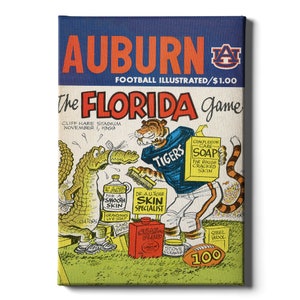 May include: A vintage illustration of a cartoon tiger wearing a blue jersey with the word "Tigers" on it. The tiger is holding a bar of soap and standing on a football field. The text "AUBURN FOOTBALL ILLUSTRATED/$1.00 The FLORIDA game CLIFF HARE STADIUM NOVEMBER 1, 1969" is at the top of the image.