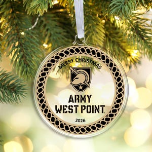 May include: A round, clear acrylic Christmas ornament featuring a black and gold braided border. The center displays the Army West Point logo, the text MERRY CHRISTMAS, ARMY WEST POINT, and the year 2026. It hangs from a white ribbon loop.