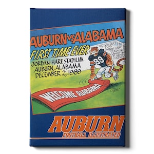 May include: A blue and orange illustration of a cartoon tiger rolling out a red welcome mat that says "Welcome Alabama". The text "Auburn vs Alabama First Time Ever" is at the top of the image. The text "Jordan-Hare Stadium Auburn, Alabama December 2, 1989" is below the tiger. The text "Auburn Football Illustrated" is at the bottom of the image.