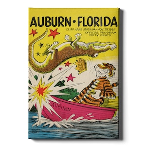 May include: A vintage program cover for the Auburn vs. Florida football game. The cover features a cartoon alligator being launched into the air by a firework, with a cartoon tiger in a boat below. The text reads "Auburn Florida, Cliff Hare Stadium - Nov. 25, 1961, Official Program, Fifty Cents."