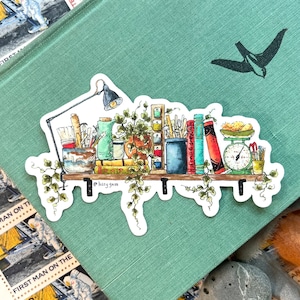 May include: A watercolor illustration of a shelf with books, plants, and other objects. The shelf is made of wood and has a white background. The illustration is surrounded by a white border.