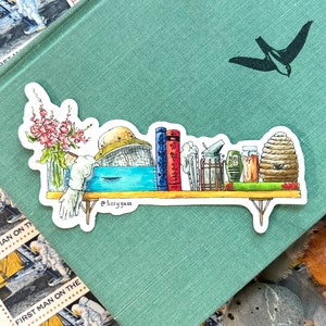 May include: A watercolour illustration of a shelf with a beekeeper's hat, books, a jar of honey, a beehive, and a bouquet of flowers. The shelf is made of wood and has a light blue background. The illustration is signed "@lizzy gass".