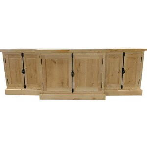 May include: A light wood cabinet with four doors and black metal hardware. The cabinet has a simple design and is made of solid wood.