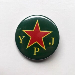 May include: A green button with a red star and the letters Y, P, and J in yellow.