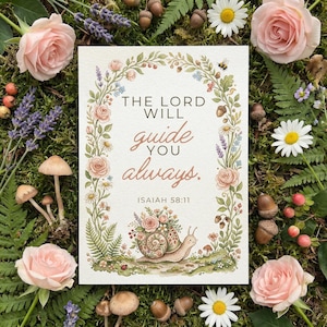 May include: A greeting card with the text "The Lord Will Guide You Always" surrounded by a floral wreath. The card features a snail with a floral shell, mushrooms, and the Bible verse Isaiah 58:11. The background is moss.