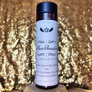 May include: A white bottle with a black cap and a label that reads "Blockbuster", "Move Obstacles", "Make vigorously before use", "Use for 3 consecutive days for maximum effect", and "400ml Bath Wash".