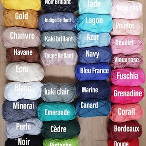 May include: A collection of yarn skeins in various colors, including citron, gold, chanvre, havane, ecru, blanc, mineral, perle, noir, noir brillant, indigo brillant, kaki brillant, taupe brillant, jade, lagon, azur, navy, bleu france, kaki clair, marine, canard, emeraude, c&egrave;dre, pistache, rose p&acirc;le, poudre, oeillet, vieux rose, fuschia, grenadine, corail, bordeaux, and rouge.