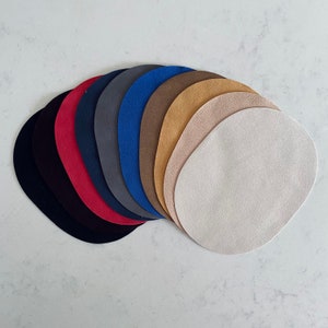 May include: A set of ten oval-shaped suede patches in various colors, including black, red, dark blue, light blue, brown, beige, and white.