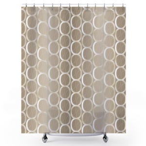May include: A shower curtain featuring a repeating geometric pattern of interlocking white and light beige oval rings on a solid tan background. The design consists of vertical columns of connected circles, creating a structured, symmetrical visual effect.