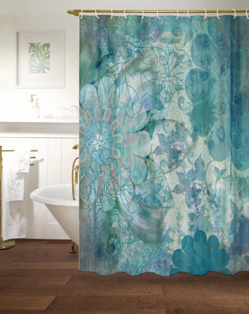 May include: A teal blue shower curtain with a floral pattern. The design features large, stylized flowers with intricate details and a faded, watercolor effect.
