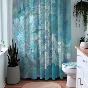 May include: A blue and white floral shower curtain with a matching toilet seat cover. The shower curtain has a watercolor effect and features a variety of flowers and leaves.