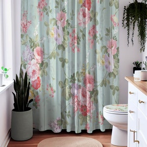 May include: A shower curtain with a floral pattern on a light blue background. The flowers are pink, red, and purple. The background has a wood grain texture.