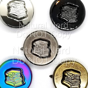 May include: Five different colored metal buttons with a stack of books design. The buttons are silver, black, antique silver, iridescent, and gold.