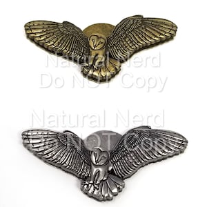 two magentic snaps in the shape of flying barn owls. Shown in bronze and antique nickel