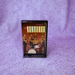 May include: A set of three ceramic mugs with a speckled, matte finish. The mugs are in shades of cream, light gray, and dark gray. Each mug has a simple, minimalist design and a rounded handle.