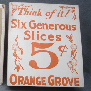 May include: Vintage orange grove box with the text "Think of it! Six Generous Slices 5¢ Orange Grove" in orange lettering on a white background. The box is open, revealing the inside.