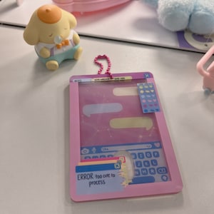 May include: A pink and white toy tablet with a keyboard, a mouse, and a message that reads "ERROR: too cute to process". The tablet has a sticker sheet with colorful hearts, stars, and other shapes.