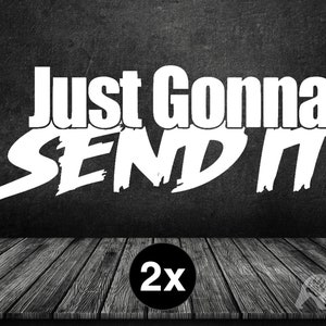 May include: White text on a dark gray background reads "Just Gonna SEND IT." A black circle with "2x" in white is at the bottom. The design is on a wooden surface.