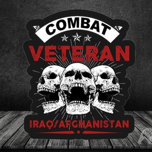 以下が含まれることがあります： 白と黒のステッカーに、赤い口をした白い頭蓋骨が3つ描かれています。ステッカーには、「Combat Veteran」という文字が白で書かれており、星が3つと、「IRAQ/AFGHANISTAN」という文字が赤で書かれています。