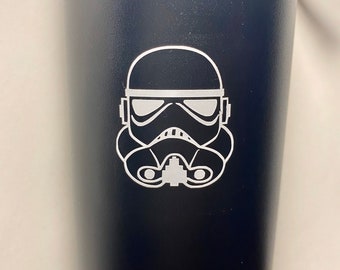 May include: Black water bottle with a white outline of a Star Wars Stormtrooper helmet.