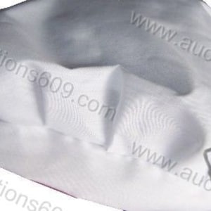 May include: White chef's hat made of fabric. The hat is folded in half and the fabric is smooth and wrinkle-free. The hat is a simple design with no embellishments.