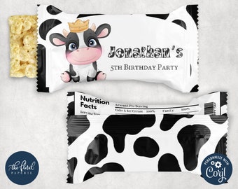 May include: A white and black cow-print favor bag with a cartoon cow wearing a crown. The bag has the text "Jonathan's 5th Birthday Party" printed on it.
