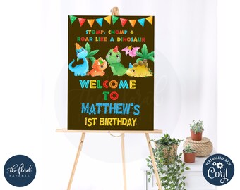 May include: A brown welcome sign with a dinosaur theme. The sign says "Stomp, Chomp & Roar Like a Dinosaur" and "Welcome to Matthew's 1st Birthday".
