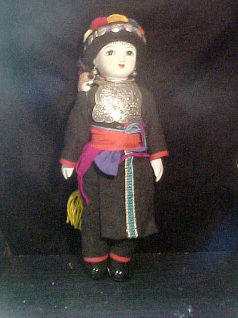 Traditional doll from Tibet or Nepal with local costume Ceramic
