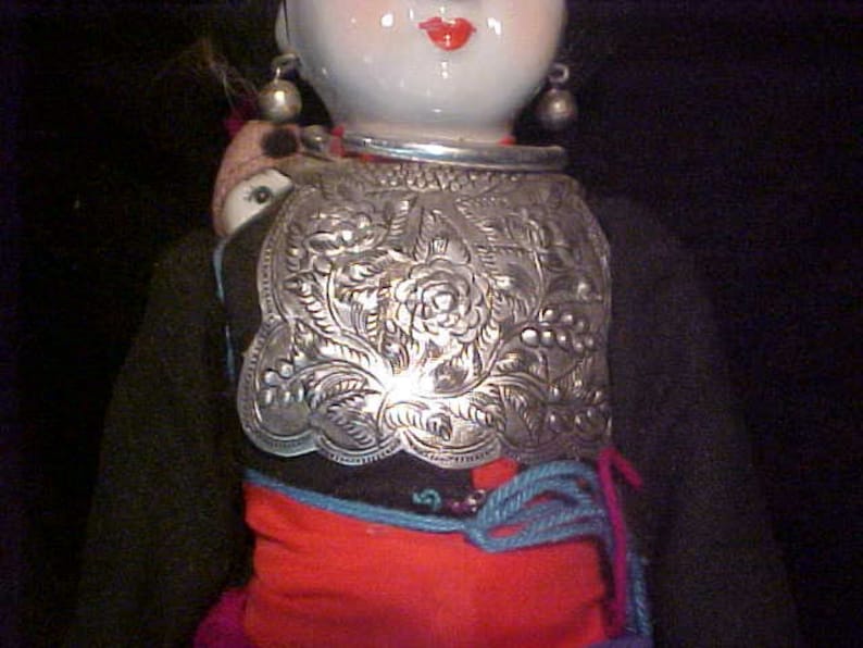 Traditional doll from Tibet or Nepal with local costume Ceramic